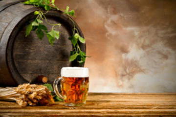 Beer keg with glass of beer and blur background