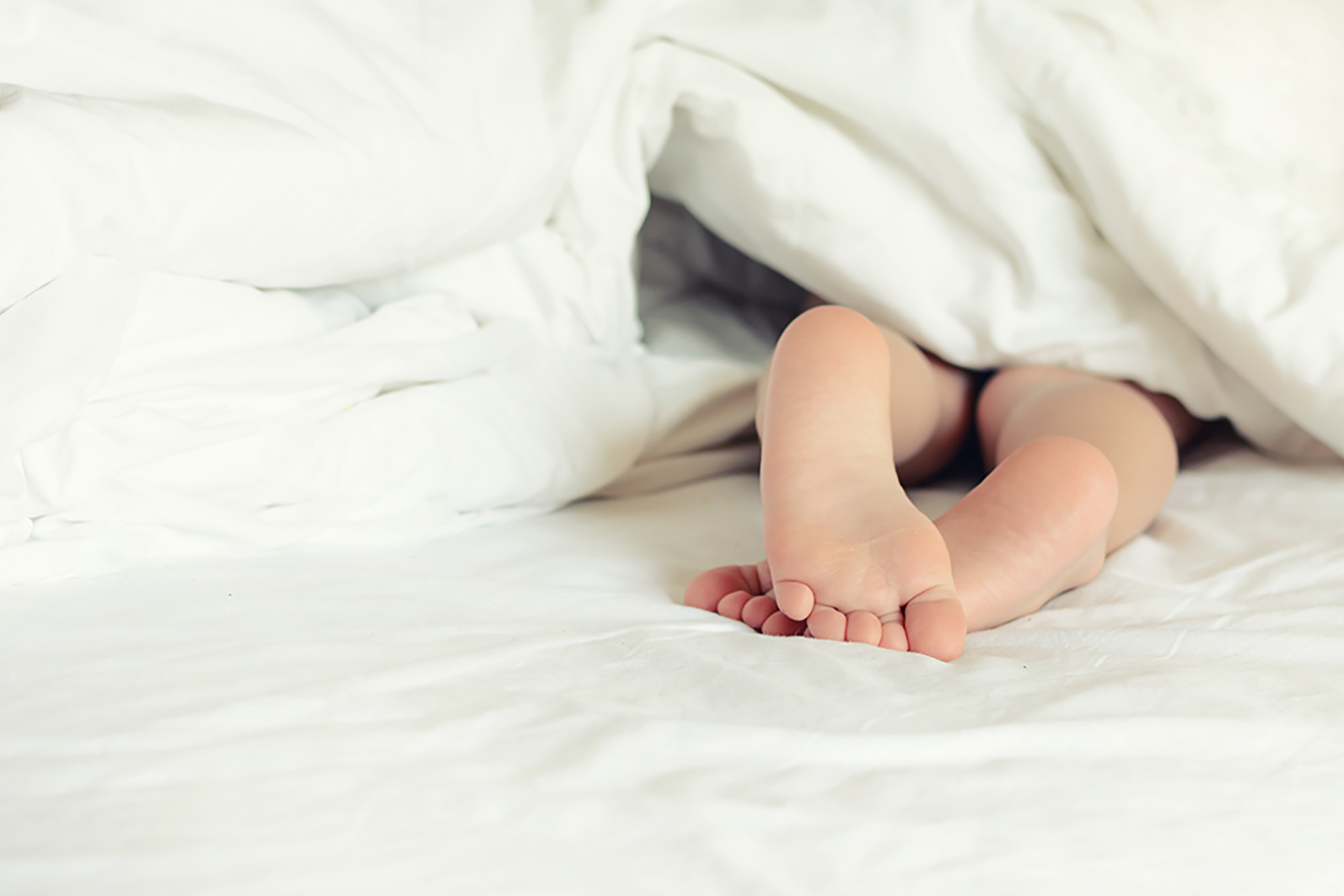 Видео ноги спящей. Детские ножки из под одеяла. Малыш выглядывает из под одеяла. Детские ноги под одеялом. Стопы детей под одеялом.