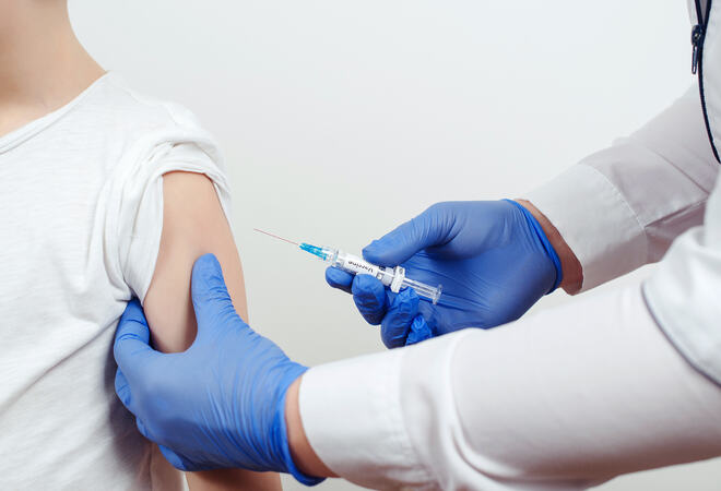 Doctor giving shot or vaccine to a patient