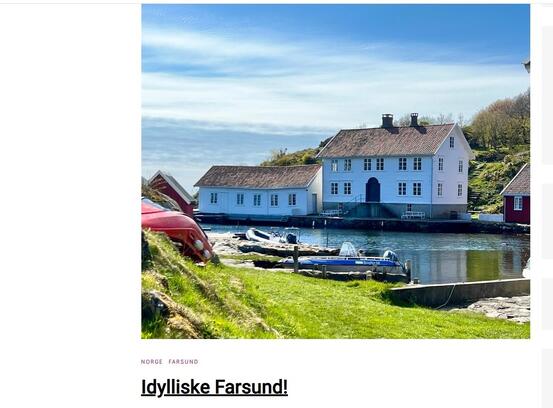 Bilde fra Loshavn med stort hvitt hus og sjø.