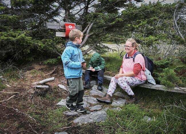 to barn på tur i skogen saman med ei dame